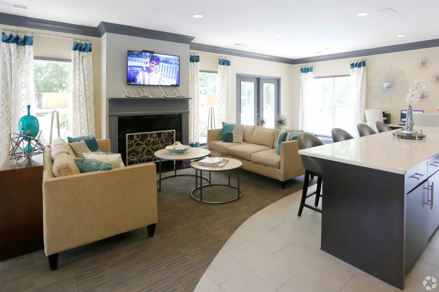 Norcross Crossings clubhouse lounge with fireplace, sofas, and bar seating